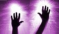 two hands up in the air radiating bright white light energy